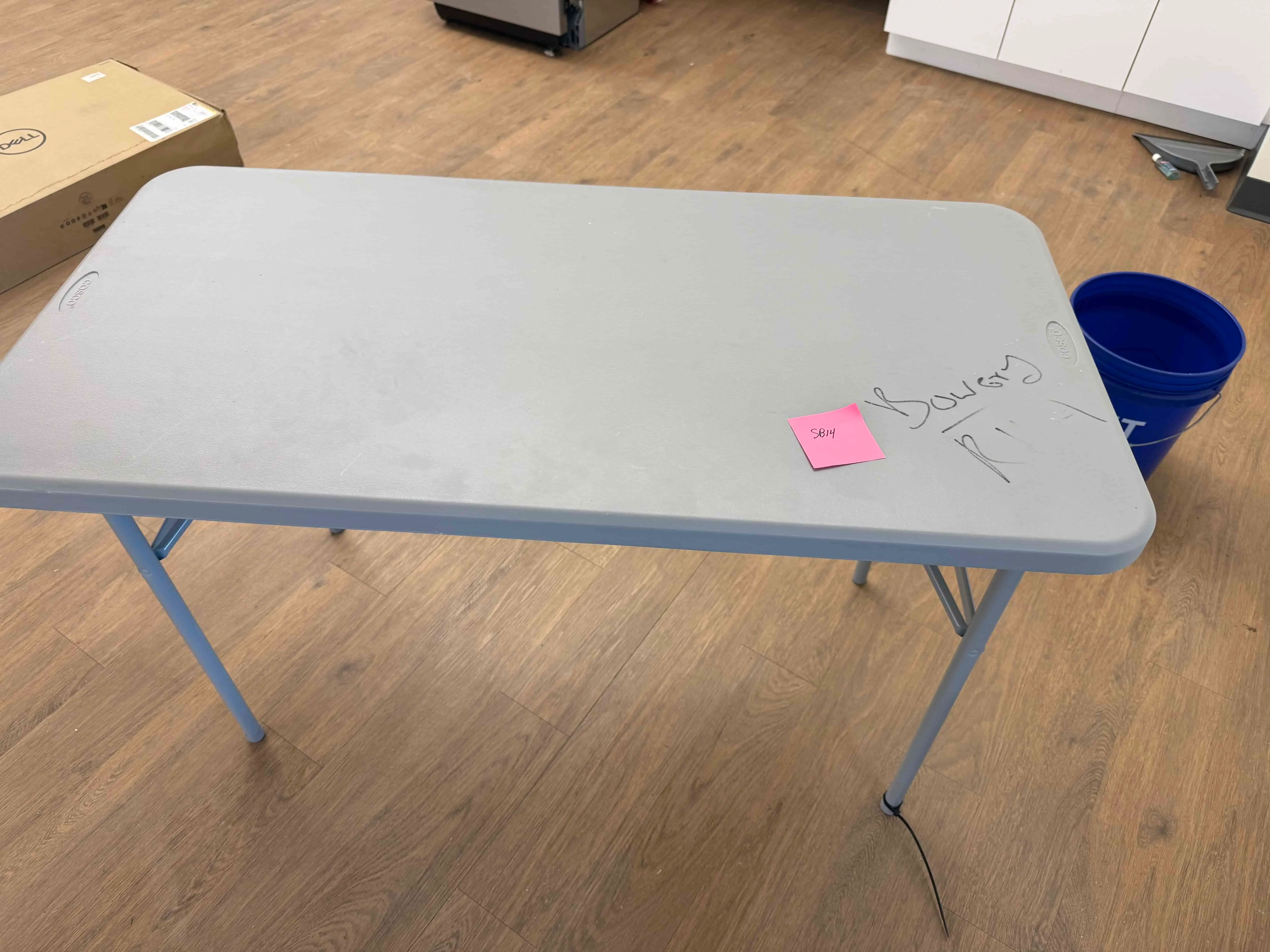SB14: Cosco lightweight folding utility table with gray plastic top and steel legs