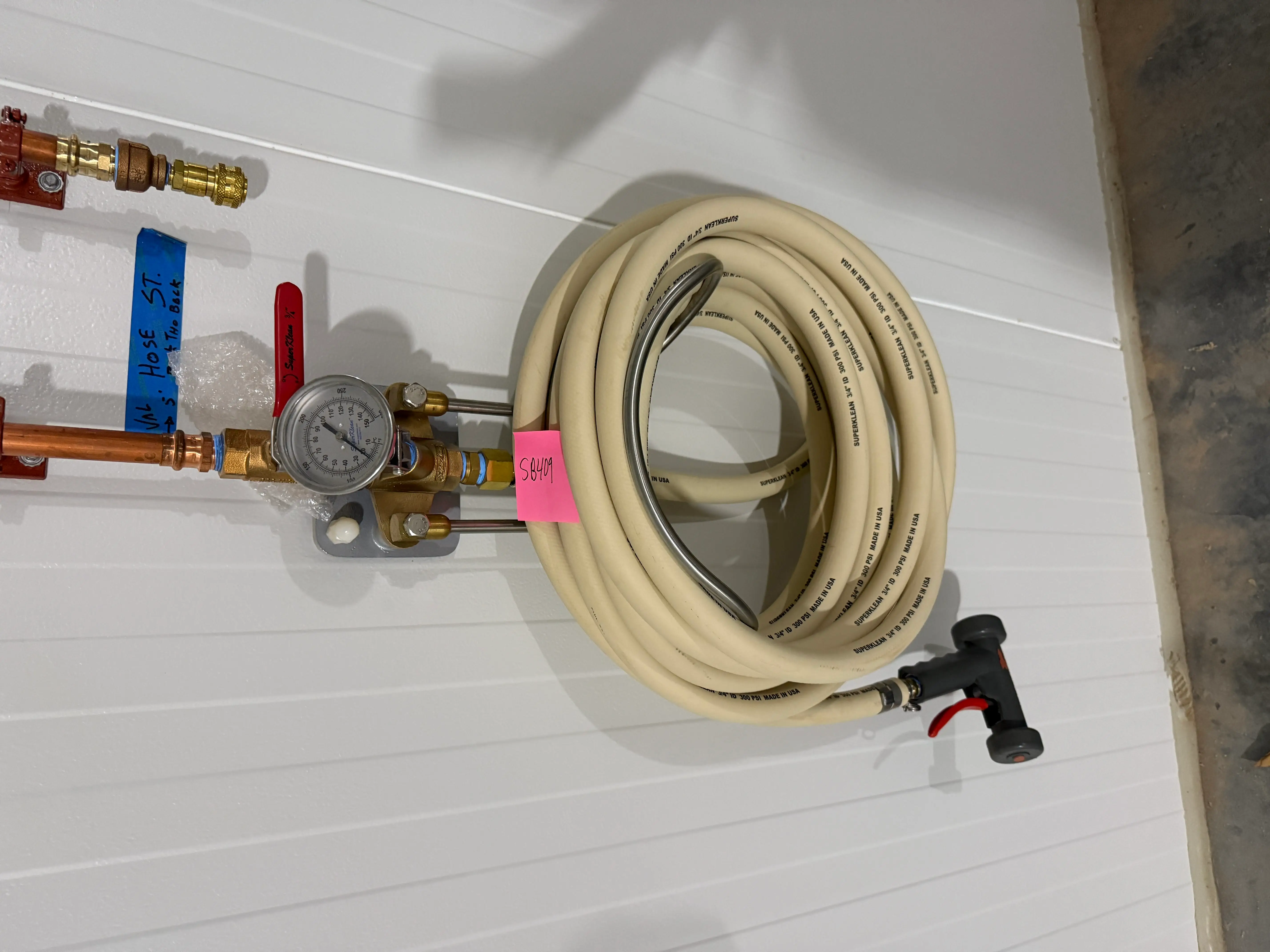 Wall-Mounted Industrial Washdown Hose Station with Pressure Gauge and Spray Nozzle